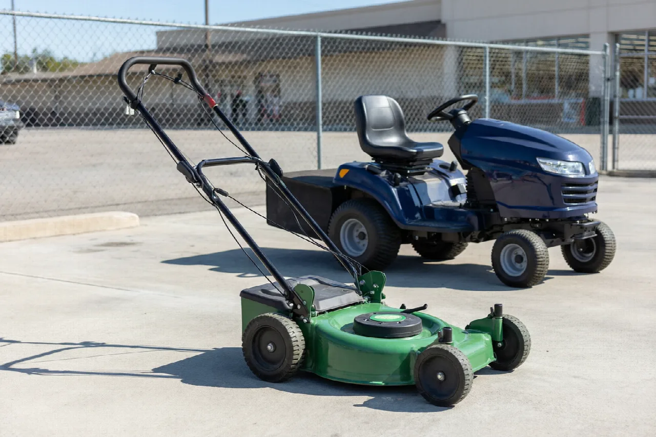 Can You Rent a Lawn Mower From Lowe's? Walk-behind and riding lawn mowers parked in an outdoor rental lot