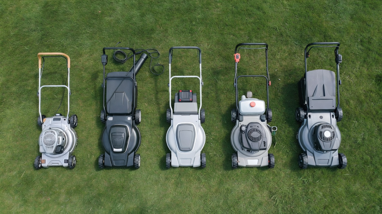 How Much Are Push Mowers? Price Ranges, Types & What Drives the Cost Five types of walk-behind lawn mowers arranged side by side on a green lawn showing design differences