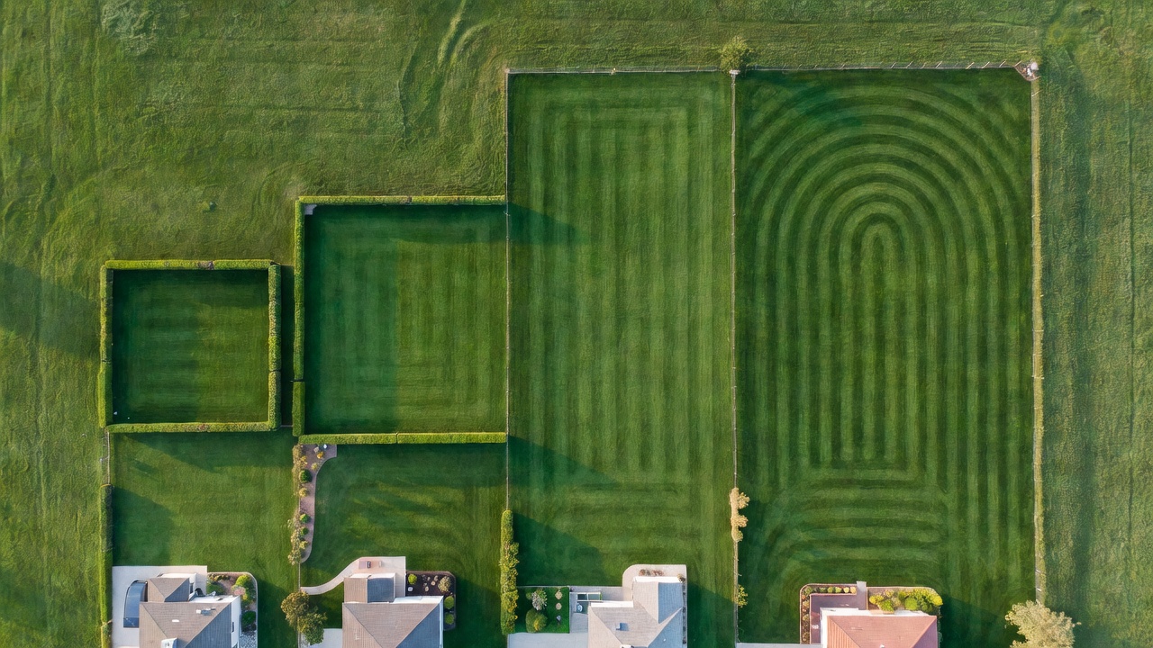 Aerial view of four residential lawns in a size progression from small to large