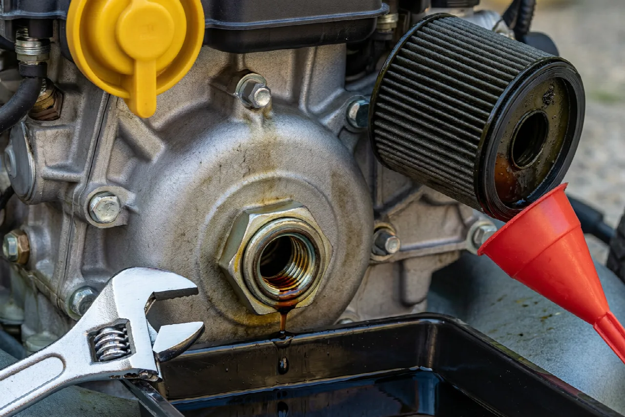 Lawn mower engine components involved in an oil change procedure