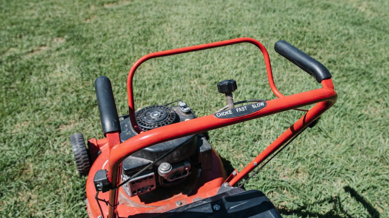 Controls on a gas-powered walk-behind lawn mower.