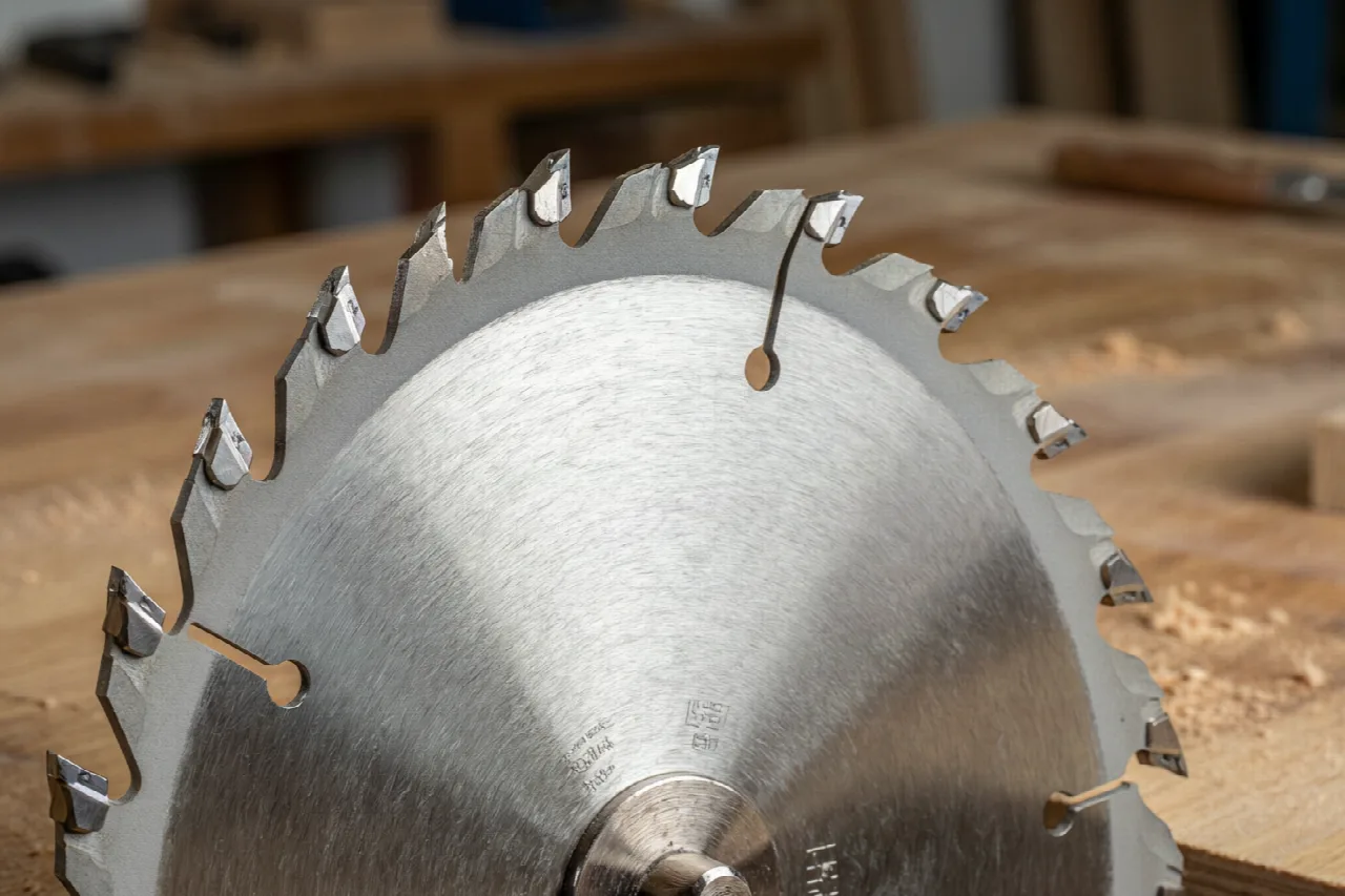What Makes a Good Circular Saw? Close-up of a circular saw blade with carbide-tipped teeth.