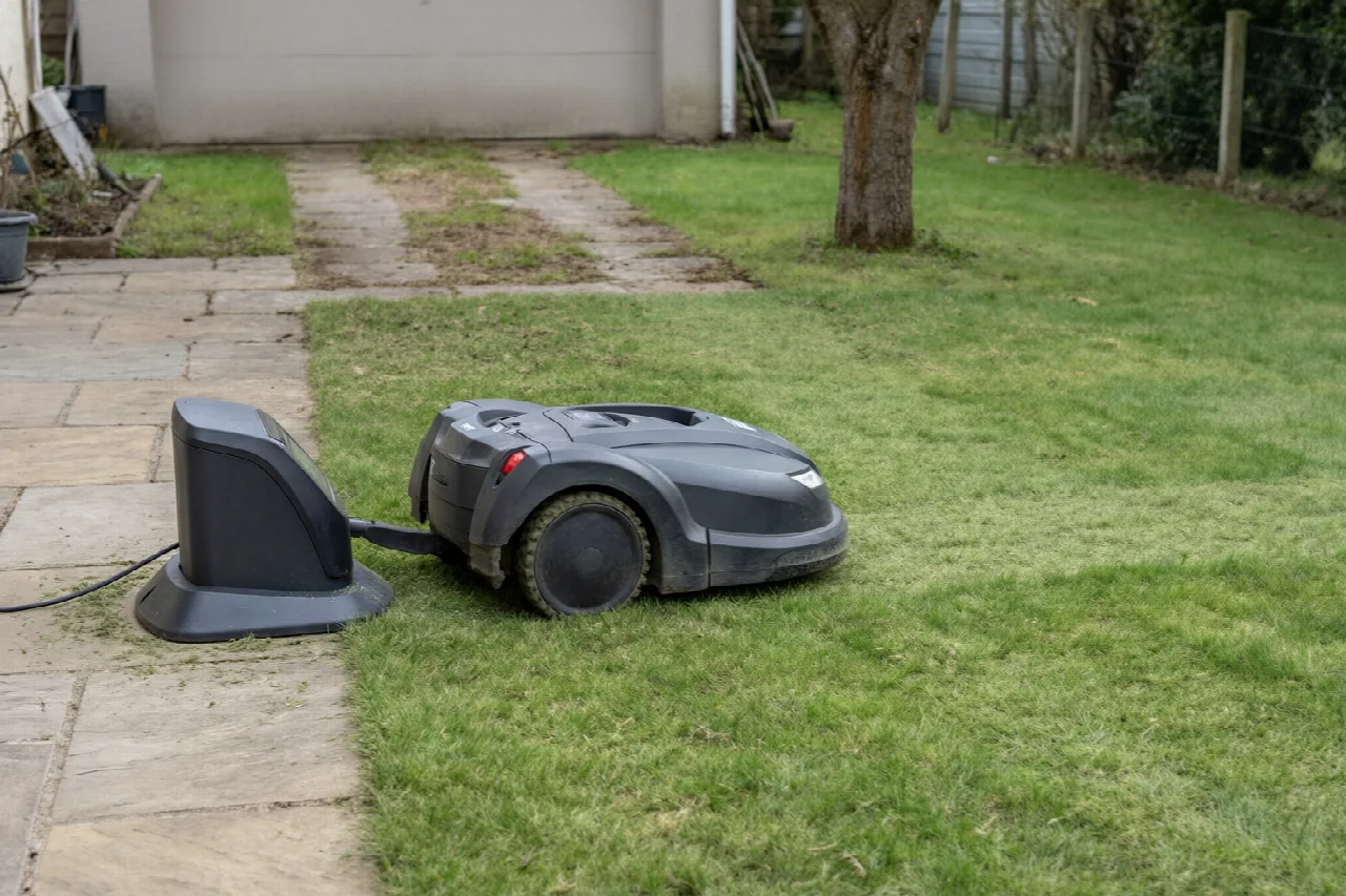 Robot mower leaving its charging station onto a short, even lawn