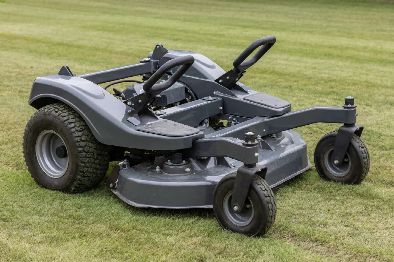 Close view of a zero-turn mower showing lap bars, rear drive tires, and front casters.