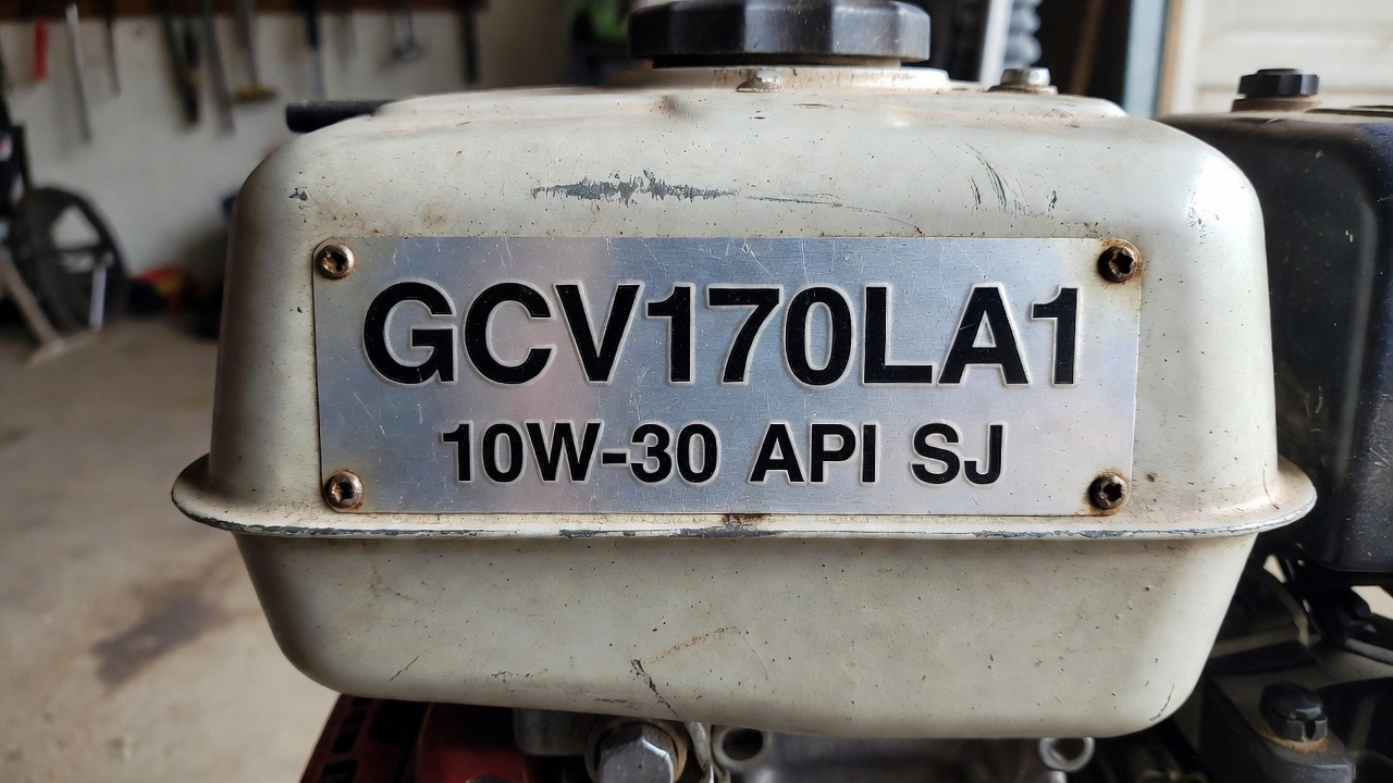 Close-up of Honda engine label showing model number and oil specification
