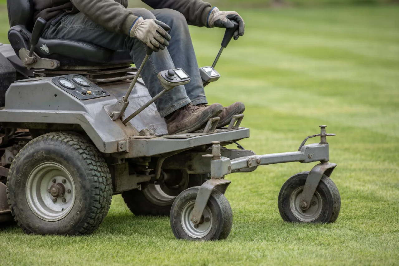 Dual levers, rear drive tires, and front casters on a riding mower